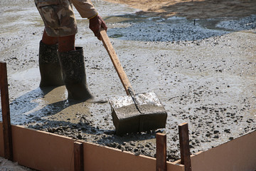 Worker standing on cement with rubber boots 