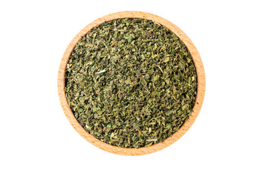 dried nettle herb or in latin Utricae folium in wooden bowl isolated on white background. medicinal healing herbs. herbal medicine. alternative medicine