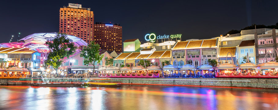 Singapore, Singapore - Aug 1, 2019 : Colorful light building at night historical riverside quay in Clarke Quay, located within the singapore river at blue hour, Popular attraction for nightlife