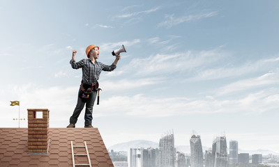 Expressive woman in helmet shouting into megaphone