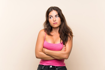 Young woman over isolated white background making doubts gesture while lifting the shoulders