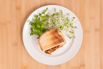 Vegan sandwich, healthy & delicious food for plant based, vegan and vegetarian diet. Ingredients are toasted bread, vegan cheese, fried tofu, tomato, watercress and kaiware sprout. Sustainable eating.