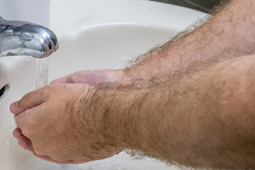 Man washing hands in basin close-up