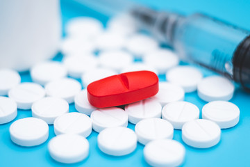 red pill close up. tablet for the treatment of pain.