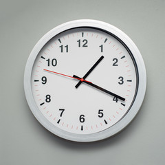 white clock on the gray wall