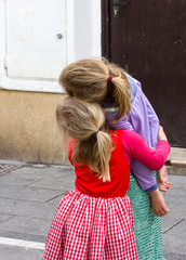 Two blond girls hugging each other