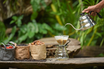 Close up of coffee brewing gadgets on wooden bar counter.
