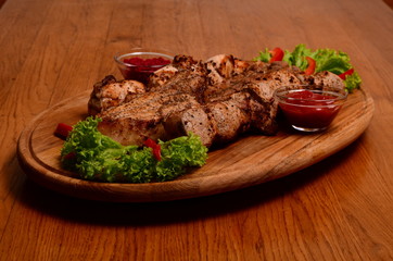 Sliced grilled beef barbecue Striploin steak with chimichurri sauce on cutting board on dark wooden background
