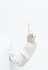 man in white gown with left hand covered with gloves pointing up on the white background