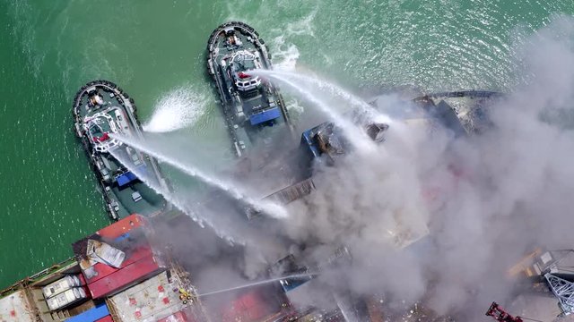 A burning fire boat Products Fire fighter during cargo fire accident at the port