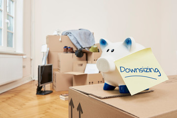 Making the apartment smaller saves money and makes less work. Stacked and packed moving boxes with...