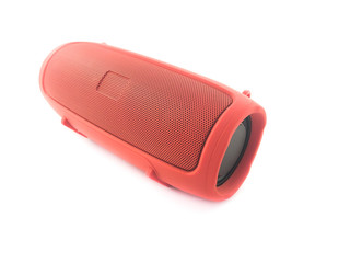 Portable speaker isolated on a white background. Red musical bluetooth speaker for travel. 