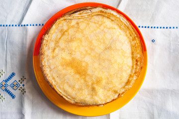 A stack of pancakes. Top view thin pancakes on a plate. Traditional rustic food.