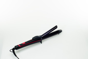 Hair iron on white background with copy space