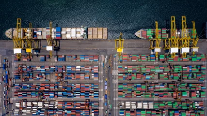 Foto op Aluminium Container ship loading and unloading in deep sea port, Aerial view of business logistic import and export freight transportation by container ship in open sea, Container loading Cargo freight ship. © Kalyakan