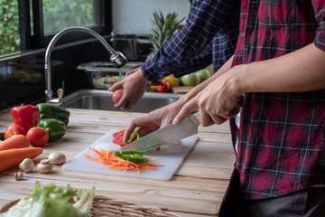 Washing fresh vegetables. A man in the kitchen.