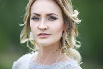 the bride walks in the field against the backdrop of the mountain