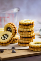 Stack of sandwich cookies with chocolate ganache filling