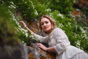 the bride walks in the field against the backdrop of the mountain