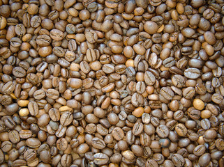 Brown roasted coffee beans Background. Fresh coffee beans ready for the grinder. 
