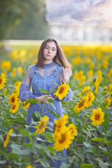 girl walks a field of sunflowers