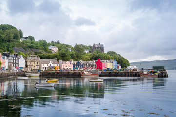 Fototapeta na wymiar Tobermory embankment with traditional colorful houses. Popular touristic town with famous distillery. Hebrides, Scotland.