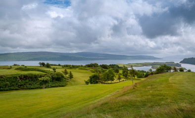Fototapeta na wymiar Scenic green fields near Tobermory. Island of Mull, Scotland.