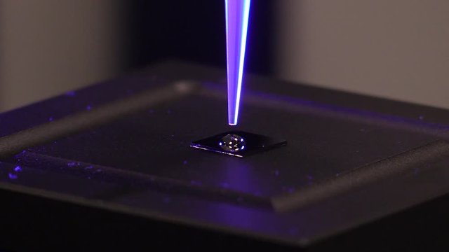 close up of a drop of liquid falls out of a pipette onto a little plate to test the surface tension of a drop of fluid. Testing the pressure of a solution in a lab. dripping a solution.