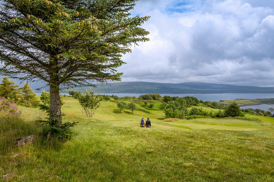 Tourist's couple walking at Islanf of Mull fields. Nature of Scotland.