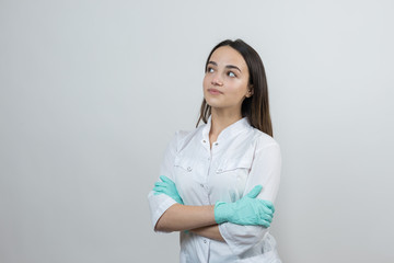 A girl doctor in latex gloves and a white coat is preparing for the procedures.