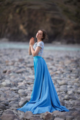 The Tale of the Mermaid. Tale of the River Nymph. Girl in a blue dress by the river.