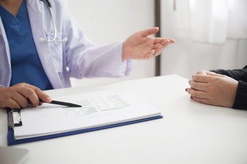 Female medicine doctor working on table with consulting patient