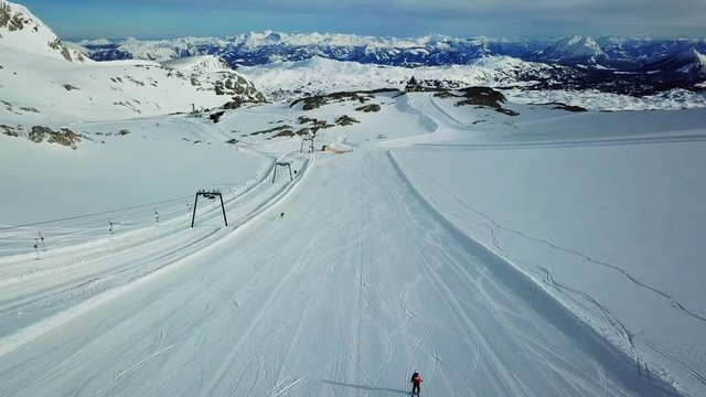 View of the Dachstein glacier ski resort from above with other mountains in the backgorund