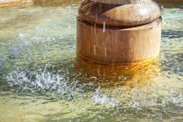 Obraz na płótnie Canvas fountain granite pillar and splashing water 