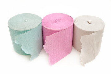 Toilet paper in three colors on a white background.
