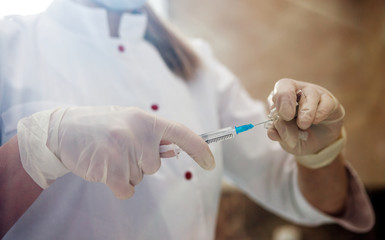 Doctor holding syringe and getting ready for injection