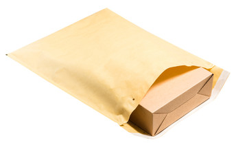 Brown cardboard box inside of large postal envelope