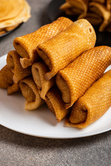 Pancakes with tasty filling on a plate. Close-up.