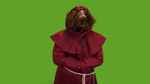 Medieval Bearded priest wearing a sword giving his blessing to the townsfolk green screen