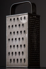 weathered grater against grey background