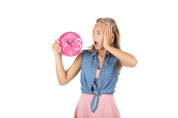 Young girl holding round clock on white background
