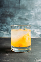 Old fahioned lemon beverage on the rustic background. Selective focus. Shallow depth of field.