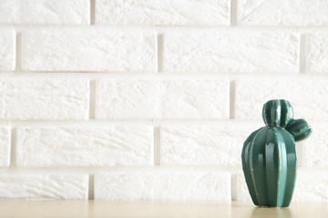 Ceramic vase on white brick wall background