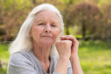 Portrait of senior woman sitting in garden