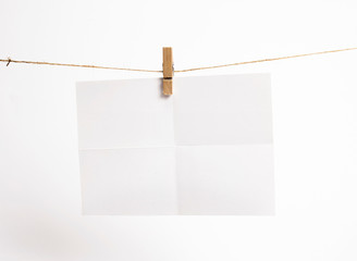 Empty paper sheets for notes, frames that hang on a rope with clothespins and isolated on white. Blank cards on rope. Mockup template for memories backdrop, photos, social media etc.
