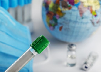Protective mask against viruses and flu during an epidemic .Medical flask for blood test.