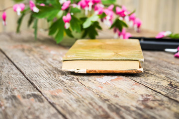 Vintage bamboo notebook on wooden shabby desk. Selective focus