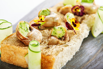 Snails with garlic and cheese side view