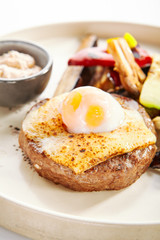 Steak with sous vide egg and baked vegetables