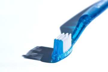 Blue Toothbrush Head with bristles shadows on White Background. Dental Health Concept.